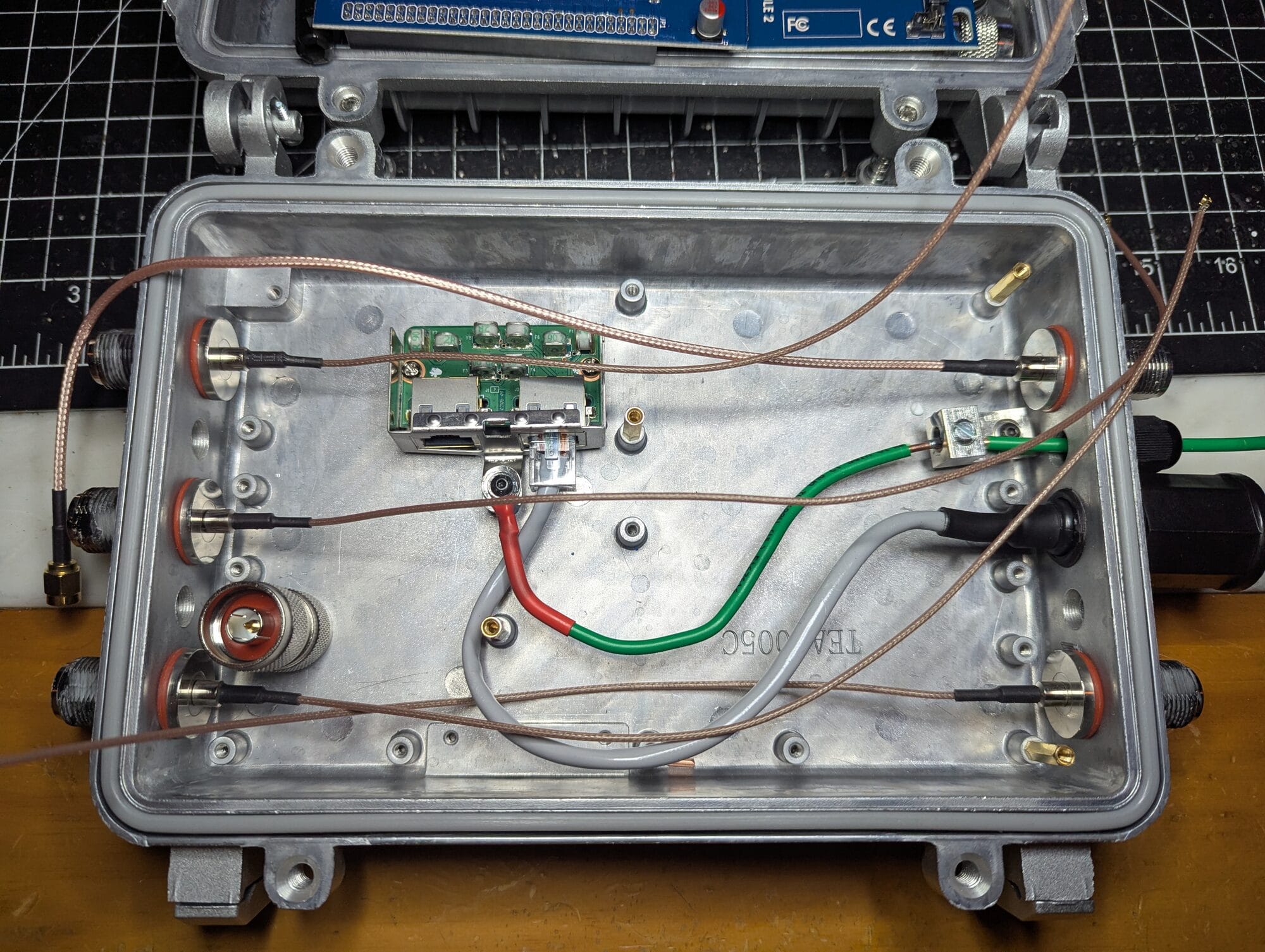 A stripped case with a shucked surge protector and the ground wiring in place.